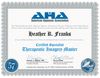 The image is a certificate from the American Hypnosis Association. It is designed with a decorative border and includes the logo of the organization at the top. The certificate states the name of the recipient and indicates that they have completed requirements to become a "Certified Specialist" in "Therapeutic Imagery Master." It features signatures from two individuals and includes details such as the date of certification and a certificate number. There is also a seal or stamp in the lower right corner.