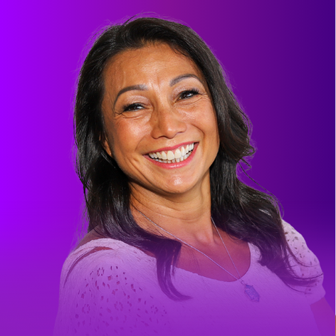 The image features a smiling woman with long, dark hair. She is wearing a light-colored top and appears to be positively engaging with the camera. The background has a gradient that transitions from purple to a lighter shade, which adds a vibrant aesthetic to the image.
