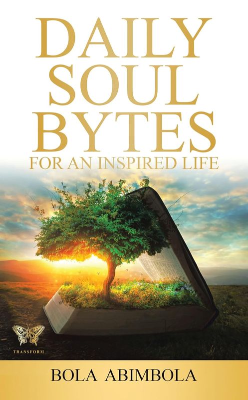 The image features a book cover with the title "Daily Soul Bytes for an Inspired Life" prominently displayed at the top. The author's name, "Bola Abimbola," is positioned at the bottom. The background depicts a scenic landscape, possibly a sunrise or sunset, with a large, open book at the center, from which a vibrant tree is growing. The overall theme suggests inspiration and growth, blending nature with literature. The color scheme includes warm tones, giving a feeling of positivity and hope.