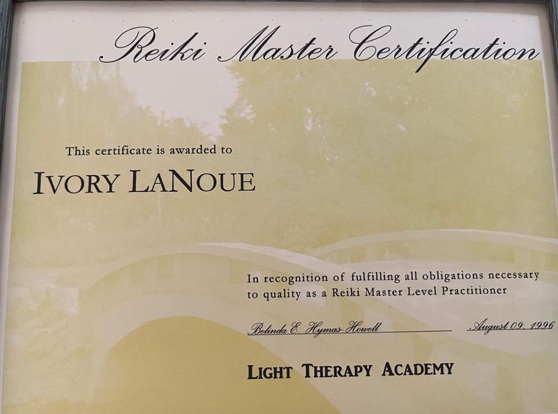 The image depicts a certificate titled "Reiki Master Certification." It indicates that the certificate is awarded to a person whose name is included on the document. It acknowledges the fulfillment of obligations necessary to qualify as a Reiki Master Level Practitioner. The certificate includes a signature and the date, as well as the name of the issuing institution, "Light Therapy Academy." The background of the certificate features a subtle design, and it is presented in a framed format.