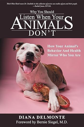 The image is a book cover. The title of the book is "Why You Should Listen When Your Animals Don’t," and it includes a subtitle that reads "How Your Animal’s Behavior And Health Mirror Who You Are." The author's name, Diana Delmonte, is also displayed, along with a foreword by Bernie Siegel, M.D.
In the image, there is a dog with a playful expression, lying down and surrounded by some colorful props, likely food items. The overall design features a pastel color scheme.