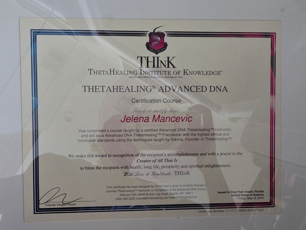 The image depicts a certificate from the ThetaHealing Institute of Knowledge, indicating that the recipient has completed a course in Advanced DNA ThetaHealing. The certificate features decorative elements, including a logo at the top, a border, and signatures that affirm the accomplishment. It includes a message of recognition for the recipient's achievements and a prayer for their well-being. The document is presented in a frame or holder, suggesting it is intended for display.