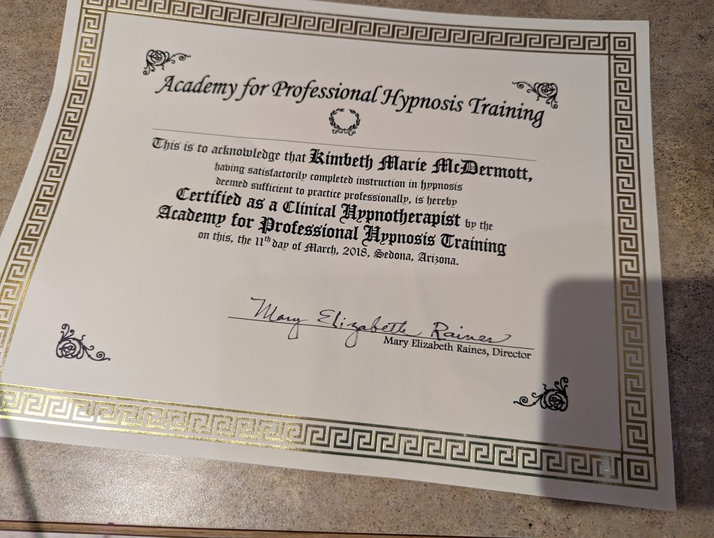 The image shows a certificate from the "Academy for Professional Hypnosis Training." The certificate acknowledges that an individual named Kimeth Marie McDermott has completed a hypnosis training program. It certifies her as a Clinical Hypnotherapist. The date of the certification is March 11, 2018, and it is issued in Sedona, Arizona. The certificate is signed by Mary Elizabeth Raines, the Director, and features decorative elements including a border.