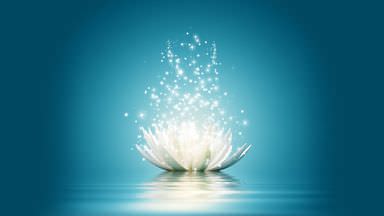 The image features a serene, stylized depiction of a white lotus flower floating on calm water. Surrounding the flower, there are sparkling particles or lights that appear to be emanating from it, creating a magical or ethereal effect. The background is a soothing gradient of blue, enhancing the peaceful atmosphere of the scene.