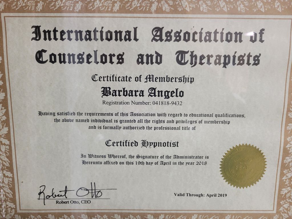 The image features a certificate from the International Association of Counselors and Therapists. It includes the name of the certificate holder, a registration number, and a statement confirming that the individual has satisfied the association’s requirements regarding educational qualifications. The certificate grants the title of "Certified Hypnotist" and includes the signature of the administrator, along with a seal or emblem. It also specifies that the certificate is valid through April 2019.