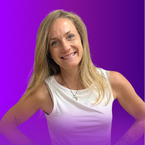 The image features a smiling woman with long, light brown hair. She is wearing a white sleeveless top and is posing with her hands on her hips. The background is a gradient of purple tones.